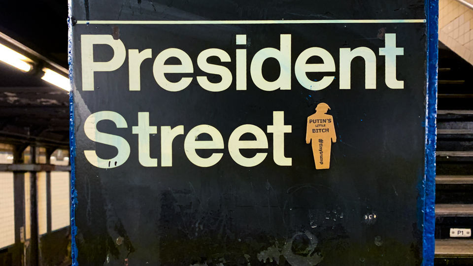 'Putins Little Bitch' tiny trump on a NYC subway sign titled 'President Street'