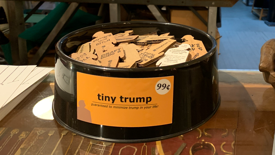 dozens of tiny trumps in a dog bowl for sale in a store (detail)