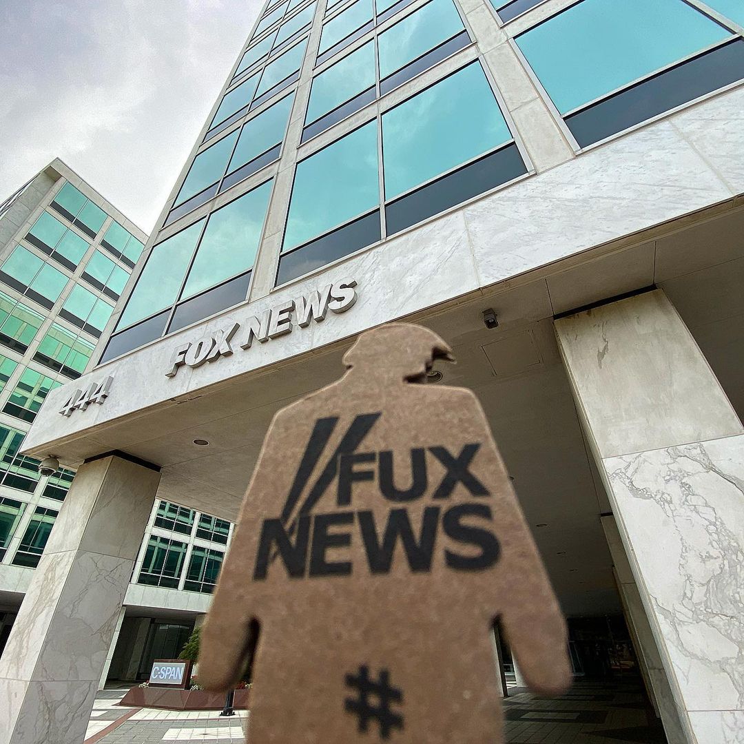 tiny trump with 'Fux News' slogan outside of Fox News
